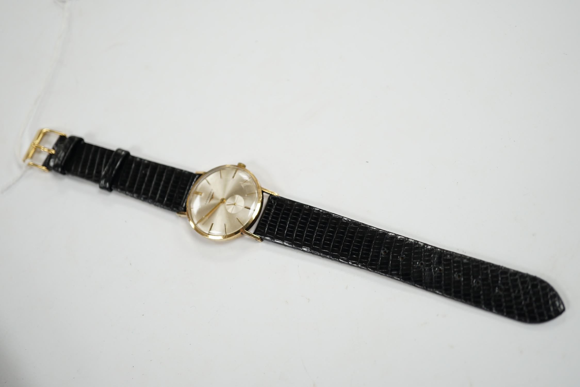 A gentleman's 9ct gold Longines manual wind wrist watch, with case back inscription, on associated leather strap. Condition - poor